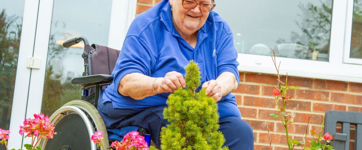 Residents sitting in the garden of a care home