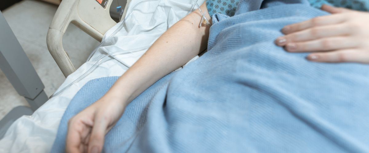A comforting hand on a patient's arm